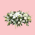 A floral casket funeral spray with a variety of flowers including white lilies and green foliage, arranged on a pink background. Brisbane Florist. Bloom and Rocket Taringa.