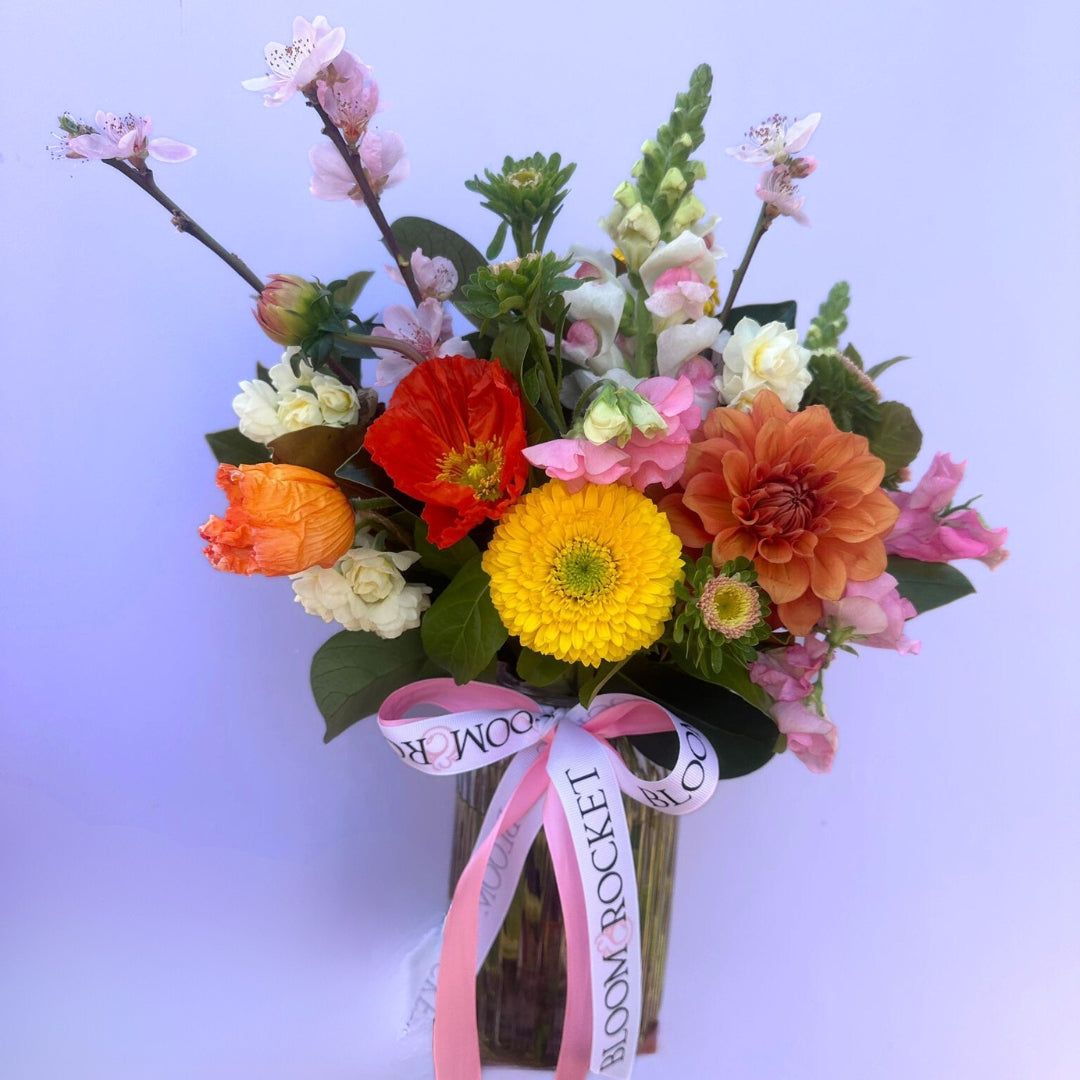 Colours of the season posy vase arrangement featuring seasonal flowers and foliage. Bloom and Rocket Florist Brisbane. Same day flower delivery.