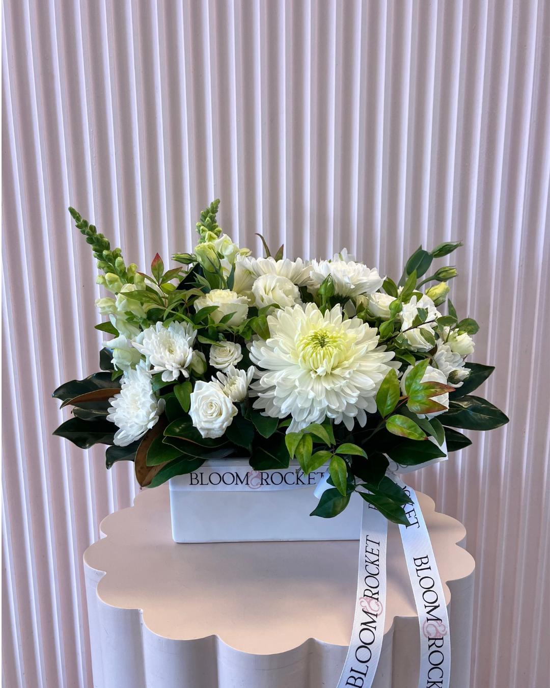 White ceramic trough arrangement featuring a selection of seasonal flowers and foliage. Bloom and Rocket Florist Brisbane.
