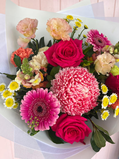 Bouquet of colorful flowers including pink and red roses, and gerberas. Bloom and Rocket Florist, Brisbane.