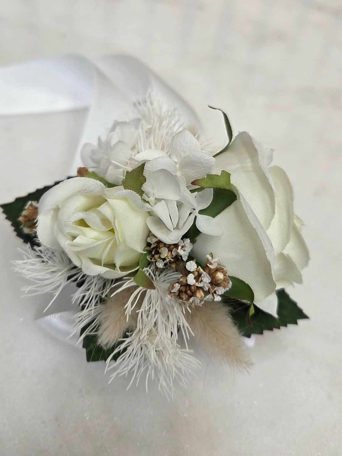 Floral corsage with white roses preserved wrist corsage.