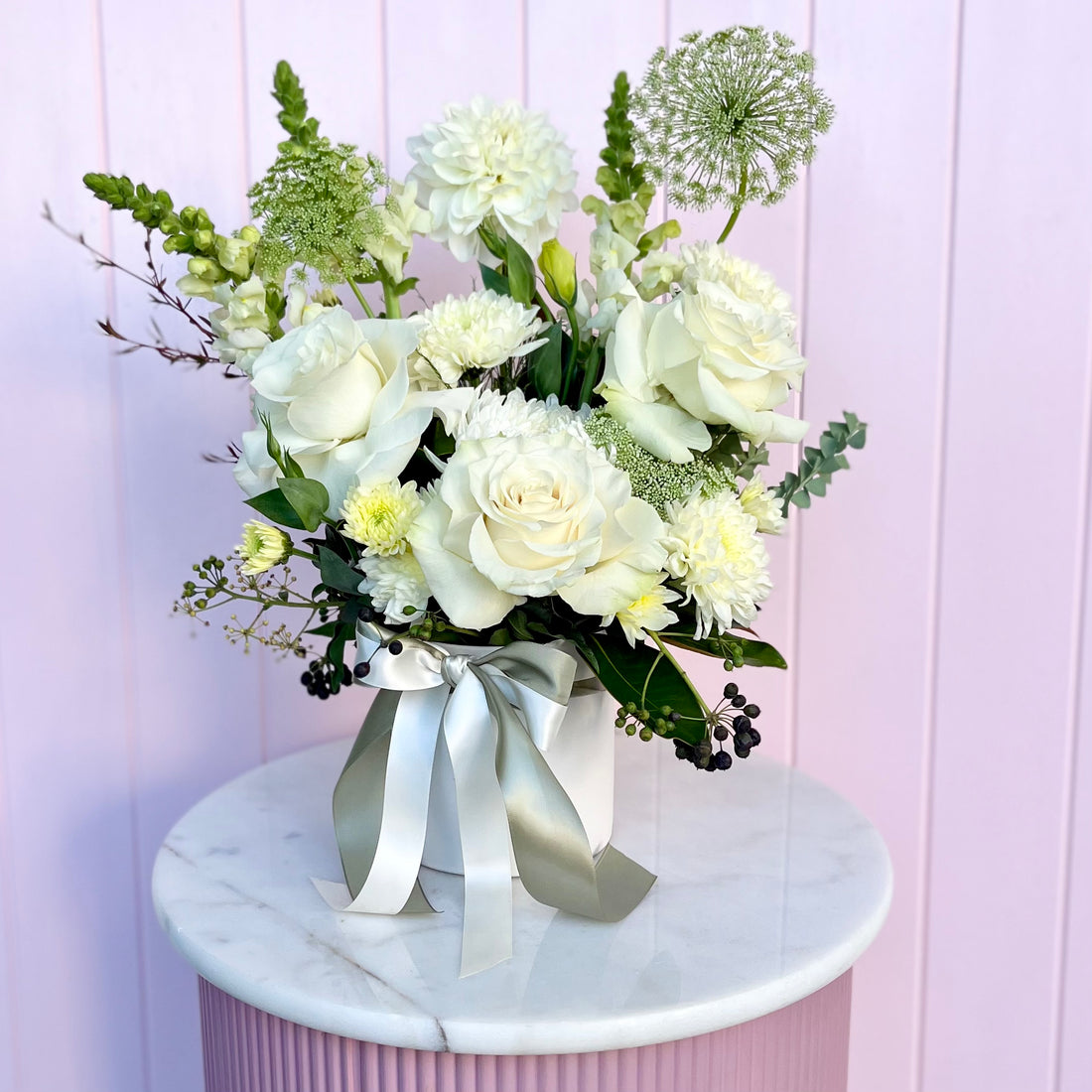 A floral arrangement with white flowers. Sympathy flowers Brisbane. Bloom and Rocket Florist.