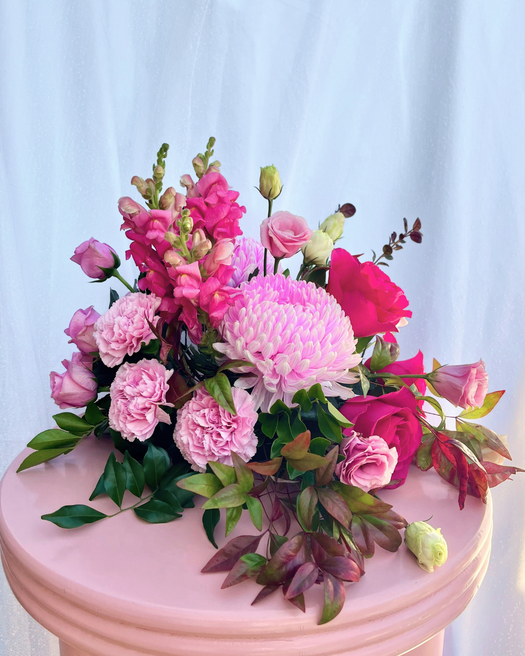 Hot pink table arrangement with a selection of seasonal flowers. Bloom and Rocket Florist, Brisbane.