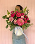 Arrangement of flowers with a variety of pink, red, and white flowers, arranged in a ceramic vase. Bloom and Rocket Florist. Brisbane Flower Delivery.