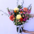 Seasonal vibes vase arrangement featuring flowers in peachy pastels arranged in a clear vase. Bloom and Rocket Florist Brisbane.
