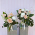 Two floral arrangements in vases with a variety of flowers including roses and lilies, green leaves and white accents. Bloom and Rocket Florist. Brisbane Flower Delivery.