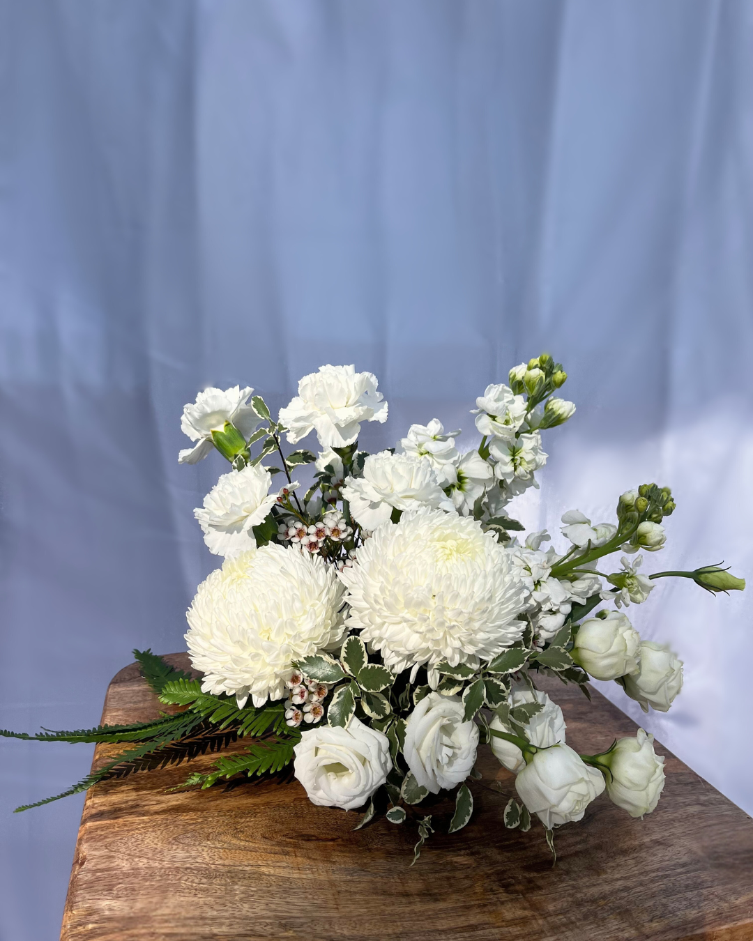 White flower table arrangement with a selection of seasonal flowers. Perfect for wedding or event florals. Bloom and Rocket Florist, Brisbane.