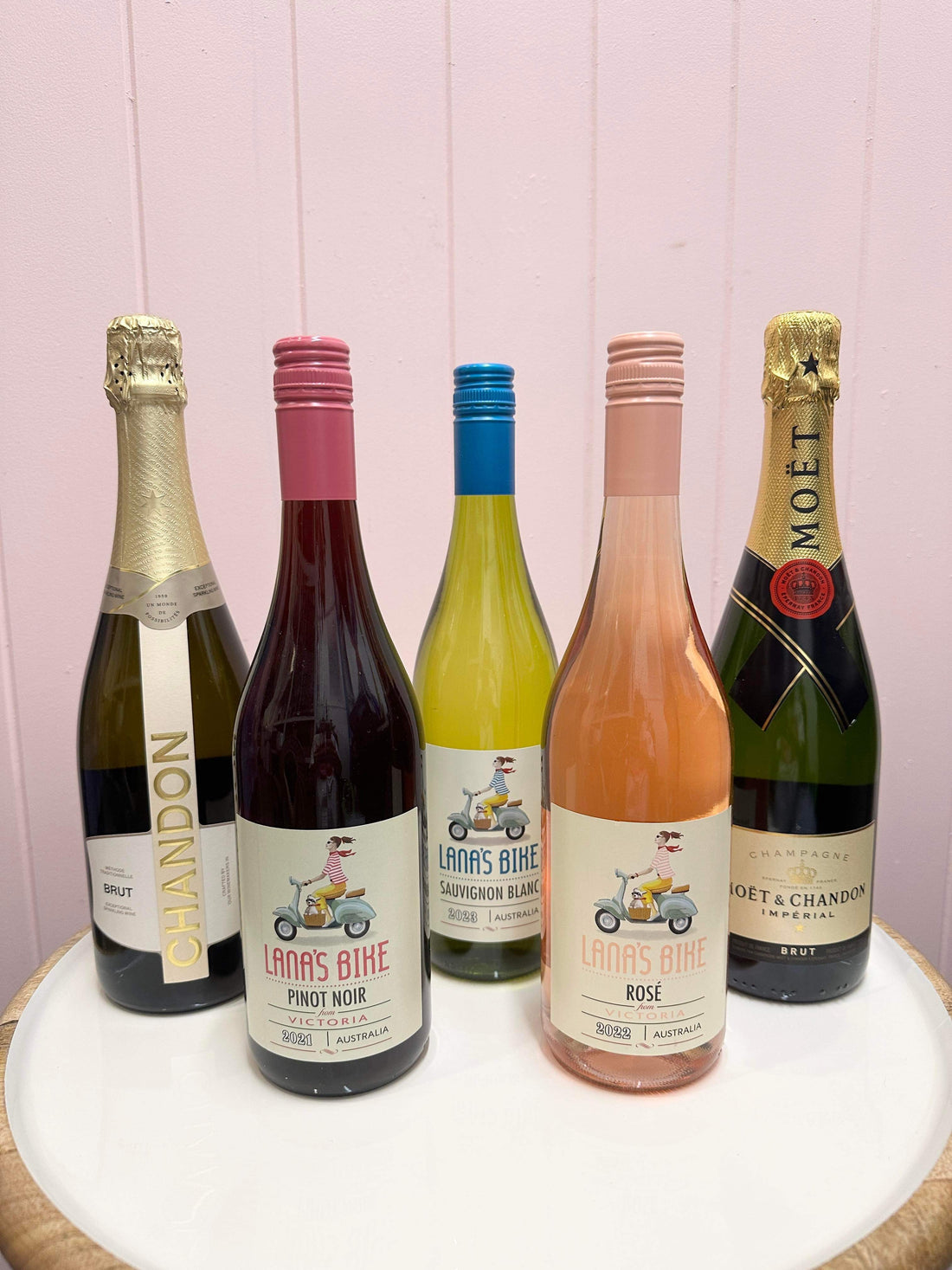 An assortment of bottled alcoholic beverages, including champagne and wine. Flowers and Wine delivery Brisbane. Bloom and Rocket Florist.